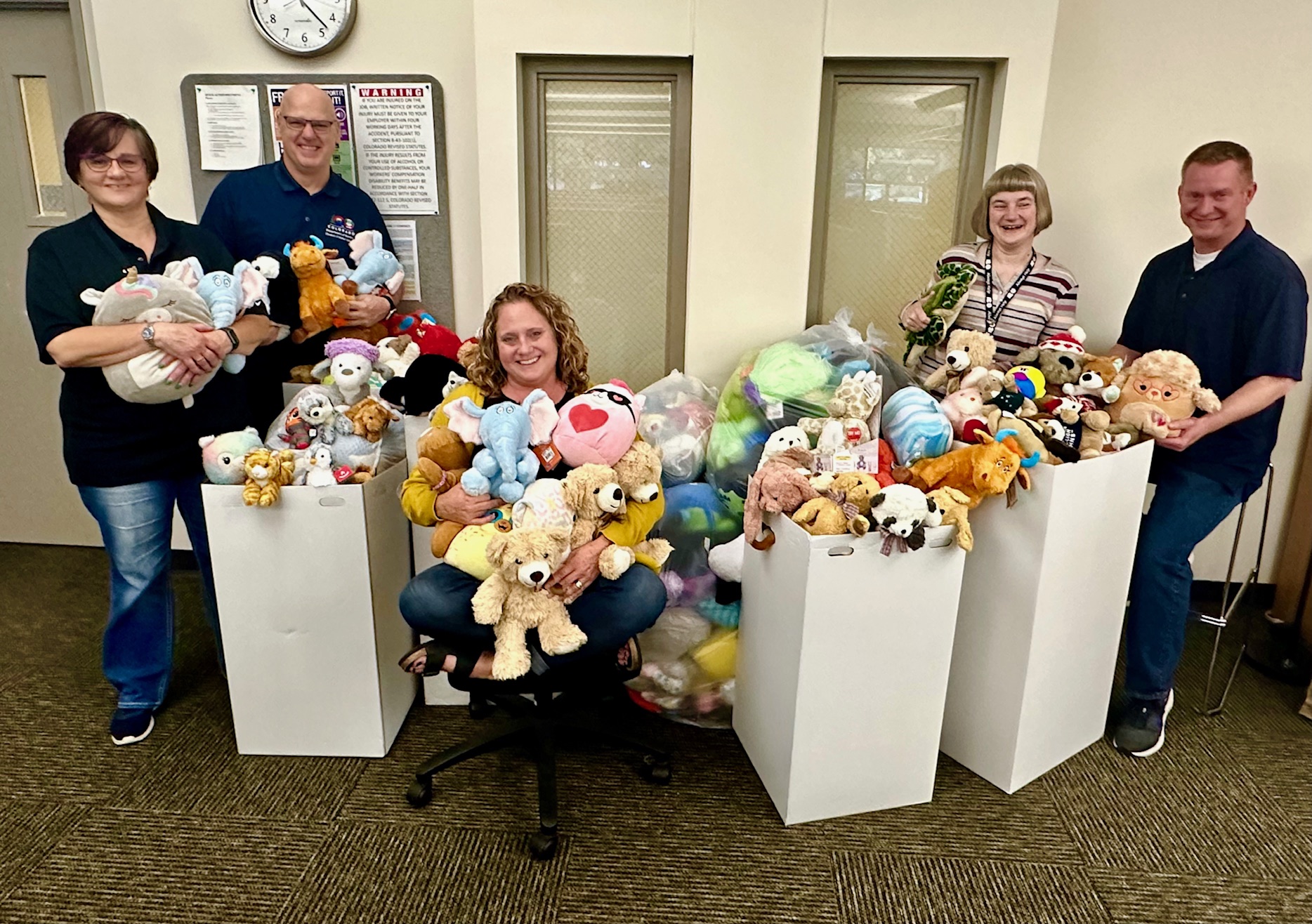 People pose with stuffed animals