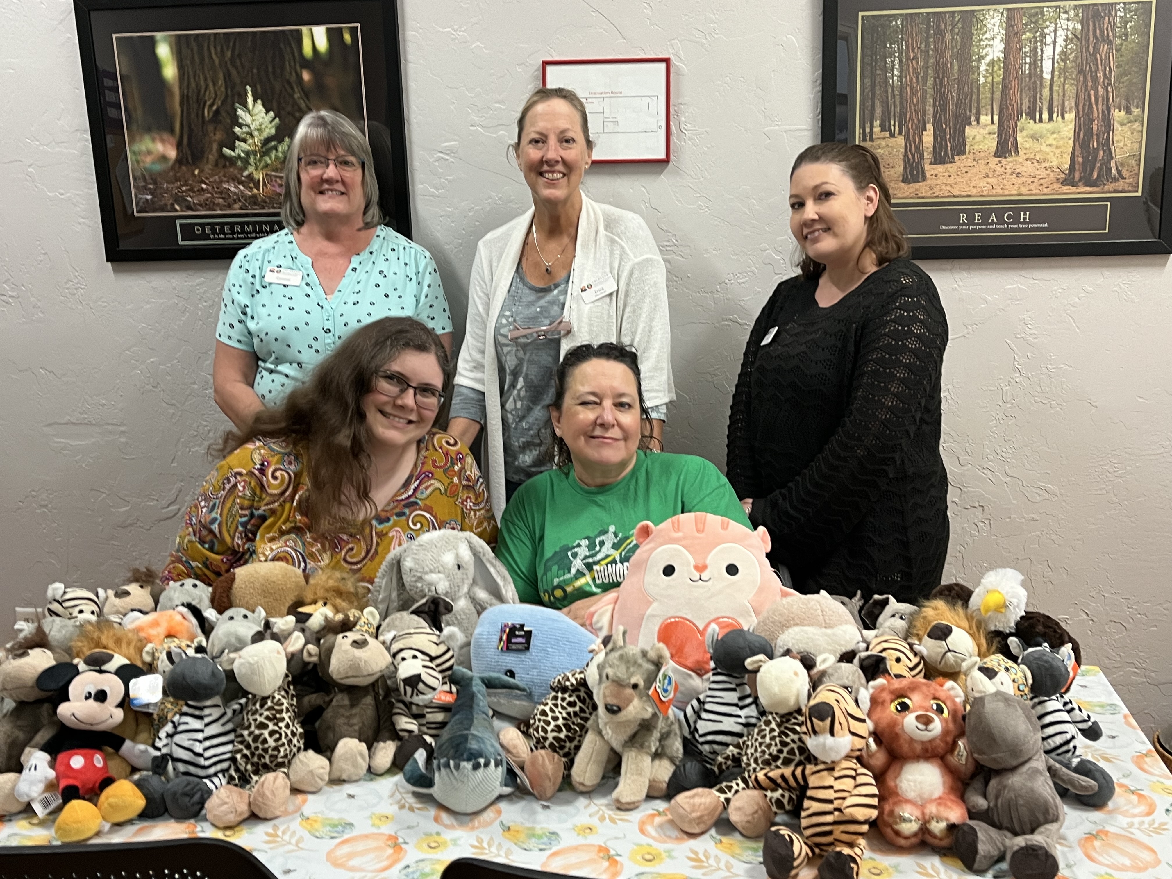 People pose with stuffed animals