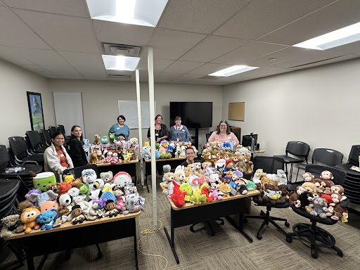 People pose with stuffed animals