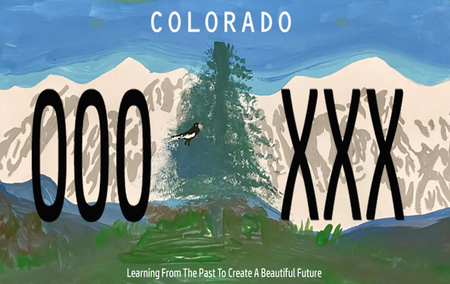 License plate of blue sky, white mountains, and an evergreen tree in the center.